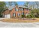 Traditional brick two story home with blue shutters, multi-car garage, and a circular driveway at 1886 Omni Blvd, Mount Pleasant, SC 29466
