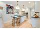 Modern kitchen with stainless steel appliances, large island with seating, white cabinetry and hardwood floors at 1886 Omni Blvd, Mount Pleasant, SC 29466