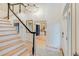 Open staircase featuring hardwood steps and a wrought iron railing at 1886 Omni Blvd, Mount Pleasant, SC 29466