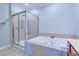 Bright bathroom featuring a glass-enclosed shower and large soaking tub with tile surround at 196 Fair Sailing Rd # 25, Mount Pleasant, SC 29466