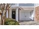 Inviting front entrance with a white door, attached garage, and manicured bushes at 196 Fair Sailing Rd # 25, Mount Pleasant, SC 29466
