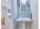 Charming powder room with a pedestal sink, stylish decor, and adjacent living room view at 196 Fair Sailing Rd # 25, Mount Pleasant, SC 29466