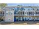 Rear view of the townhomes featuring screened-in porches and yard space at 196 Fair Sailing Rd # 25, Mount Pleasant, SC 29466