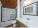 Bathroom featuring wood-paneled ceiling, and a white sink and vanity with mirrored backsplash and a glass enclosed tub and shower at 2015 Albert Storm Ave, Moncks Corner, SC 29461