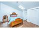 Bedroom with bright light from skylight, rustic wood floors, and quaint wooden bedframe with decorative headboard and footboard at 2015 Albert Storm Ave, Moncks Corner, SC 29461
