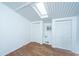Bedroom featuring hardwood floors, skylight, and white closet doors, with white walls and paneled ceiling at 2015 Albert Storm Ave, Moncks Corner, SC 29461