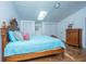 Bedroom with bright light from skylight and view of closet, dresser and bed with unique wooden frame and headboard at 2015 Albert Storm Ave, Moncks Corner, SC 29461