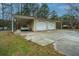 Detached two car garage with attached carport, concrete driveway, vehicle and well-maintained lawn at 2015 Albert Storm Ave, Moncks Corner, SC 29461