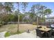 Spacious backyard with wooden fencing, a patio dining set, and a grassy area for outdoor enjoyment at 2025 Lanneau Ln, Johns Island, SC 29455