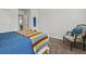 Bedroom with an upholstered chair, large bed with colorful blanket, and neutral walls at 2025 Lanneau Ln, Johns Island, SC 29455