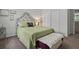 Cozy bedroom featuring a decorative headboard, a comfortable bed with green linens, and a stylish bench at 2025 Lanneau Ln, Johns Island, SC 29455