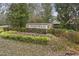 Welcome to Oakfield, beautifully landscaped community entrance with stone signage at 2025 Lanneau Ln, Johns Island, SC 29455