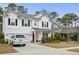 Charming two-story home boasts black shutters and a two-car garage at 2025 Lanneau Ln, Johns Island, SC 29455