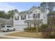 Charming two-story home features a bright red front door and a two-car garage at 2025 Lanneau Ln, Johns Island, SC 29455
