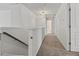 Upstairs hallway with carpet, three doors, and a view of a bathroom at 2025 Lanneau Ln, Johns Island, SC 29455