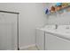 Bright laundry area with washer, dryer, and convenient overhead shelving for storage solutions at 2025 Lanneau Ln, Johns Island, SC 29455