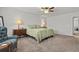 A well lit main bedroom featuring carpet, a ceiling fan, and neutral walls and decor at 2025 Lanneau Ln, Johns Island, SC 29455