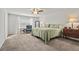 A well lit main bedroom featuring carpet, a ceiling fan, and neutral walls and decor at 2025 Lanneau Ln, Johns Island, SC 29455