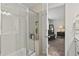 The walk-in shower featuring glass doors, seating, and tile surround at 2025 Lanneau Ln, Johns Island, SC 29455