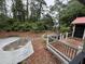 An image of the deck looking out into a secluded backyard surrounded by lush greenery and walkways at 204 Chamblee Rd, Walterboro, SC 29488