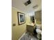 This bathroom features a single sink vanity, a toilet, neutral decor, and a framed art piece at 204 Chamblee Rd, Walterboro, SC 29488