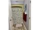 The charming bathroom includes a floral shower curtain, single vanity, and a toilet at 204 Chamblee Rd, Walterboro, SC 29488