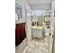 A well-lit bathroom with a gray wall and decorative plates, a single vanity sink, and a toilet at 204 Chamblee Rd, Walterboro, SC 29488