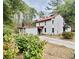 Charming two-story home with a red roof, mature trees and a beautiful garden at 204 Chamblee Rd, Walterboro, SC 29488
