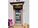 Close-up of the front door and the number 204 with pink chair and a clay jar at 204 Chamblee Rd, Walterboro, SC 29488