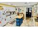 Bright kitchen features white cabinetry, kitchen island and a view into another room at 204 Chamblee Rd, Walterboro, SC 29488
