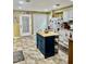 Spacious kitchen with a blue island, white cabinets, and a tiled floor at 204 Chamblee Rd, Walterboro, SC 29488
