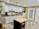 Well-lit kitchen with white cabinets, an island, and modern appliances at 204 Chamblee Rd, Walterboro, SC 29488