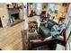 The cozy living room has a brick fireplace, hardwood floors, and multiple sitting areas, creating a warm and inviting atmosphere at 204 Chamblee Rd, Walterboro, SC 29488