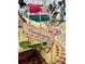 A rustic metal bed frame with a yellow mattress has a sign that says, 