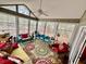 The sunroom features floor-to-ceiling windows and colorful furniture, perfect for relaxation and enjoyment of the outdoors at 204 Chamblee Rd, Walterboro, SC 29488