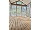 Sunroom with wood floors and many windows for enjoying the outdoors in any weather at 204 Chamblee Rd, Walterboro, SC 29488