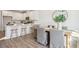 Open kitchen with a large island, wood flooring, white cabinets, and nearby dining area at 207 Abercom Place Dr, Moncks Corner, SC 29461