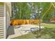 Spacious backyard with a basketball court, a wooden picnic table, and a wooden fence at 208 Kentucky Dr, Ladson, SC 29456