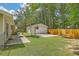 A backyard and converted garage with a basketball hoop, and a wooden picnic table, with a wooden fence at 208 Kentucky Dr, Ladson, SC 29456