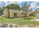 Backyard featuring a yellow-colored house with a fenced area and a lawn with an extra building at 208 Kentucky Dr, Ladson, SC 29456
