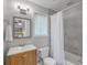 Updated bathroom with wood vanity, decorative mirror and tiled shower with tub at 208 Kentucky Dr, Ladson, SC 29456