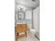 Updated bathroom with wood vanity, decorative mirror and tiled shower with tub at 208 Kentucky Dr, Ladson, SC 29456