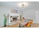 Dining room featuring a decorative fireplace, chandelier, and wood flooring at 208 Kentucky Dr, Ladson, SC 29456