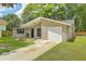 A charming single-story home with a brick accent wall and a well-manicured lawn at 208 Kentucky Dr, Ladson, SC 29456