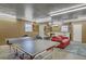 This is a garage that has been repurposed into a game room with a ping pong table and couch at 208 Kentucky Dr, Ladson, SC 29456