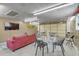 This is a garage that has been repurposed into a game room with a ping pong table, couch, and tables at 208 Kentucky Dr, Ladson, SC 29456