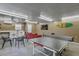 This is a garage that has been repurposed into a game room with a ping pong table and couch at 208 Kentucky Dr, Ladson, SC 29456