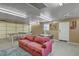 This is a garage that has been repurposed as a living room with a ping pong table and couch at 208 Kentucky Dr, Ladson, SC 29456