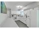 Well-lit kitchen features white cabinets and appliances and modern gray tile flooring at 208 Kentucky Dr, Ladson, SC 29456