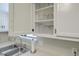 Close up shot of kitchen sink and cabinets with glassware displayed on shelves above at 208 Kentucky Dr, Ladson, SC 29456